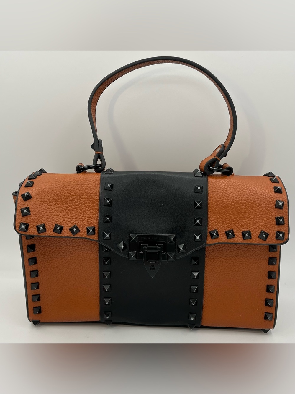 Constance Stud-Trim Two-Tone faux Leather Top-Handle Bag in Brown and Black.